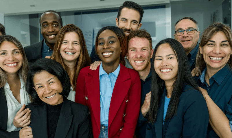 A diverse group of smiling professionals in a workplace